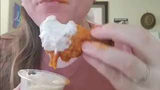 Sucking and slurping Buffalo flavored chicken wings. Ranch and Blue cheese dips! Yum