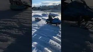 Braden (7) pulling Brielle (5) in a tube behind his 120cc snowmobile
