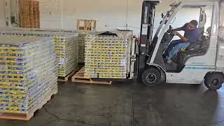 Using a Slip Sheet Forklift to Load Goods onto a Pallet | Material Handling