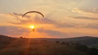 Trike spider paramotor flying over the summer sunshine, pilot Lucian learning too fly at paramotor