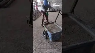 Person using a cart to transport materials, a construction