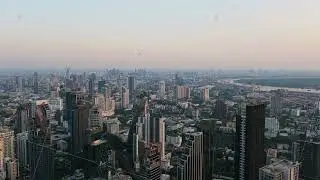 Aerial view of Bangkok's modern cityscape with high rise buildings and skyscrapers during a sunset