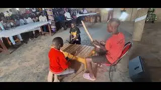 Kids from rural areas in Uganda playing xylophone during music camp at Chrysalis Secondary School