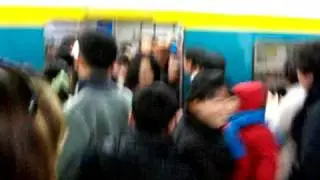 Getting on a packed Seoul subway train.