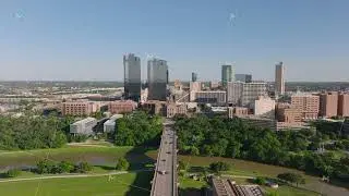 Fort Worth, Texas, showcasing downtown skyline with its corporate buildings, green areas, and roads