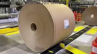 Harmax conveys rolls to Bobst Turret Splicer.  NO clamps around operators.