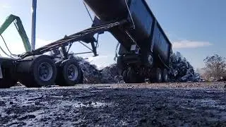 Unloading scrap with frameless end dump 