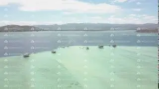 Drone fly over in a remote sandbar with aqua and turquoise blue sea.
