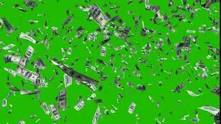 Flying dollar bills in fast motion in front of a green screen.