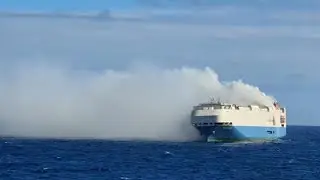 A burning cargo ship full of Porsches and VWs is adrift in the