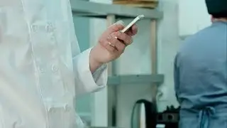 Male Chef's Hands Holding Mobile Phone in the Restaurant Kitchen | Stock Footage - Videohive