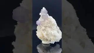 Stepped ball shaped fluorite cluster, on a milky quartz matrix .From Shangbao Mine