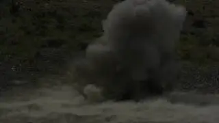Fiery explosion in slow motion, shock wave visible.