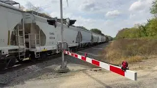 Vintage BNSF engine pulls short hopper car train westbound on the Aurora Subdivision