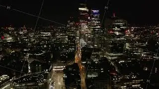 Tilt up reveal of tall modern buildings, skyscrapers in City business district. Aerial view of city