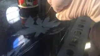Handpainting the acid resist before acid etching glass with hydrofluoric acid.
