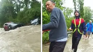 Stranded Drivers Use Tow Line to Escape Raging Flood Waters