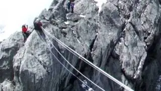 Ashley Hale on the tyrollean traverse on the summit ridge of Carstensz Pyramid in Papua