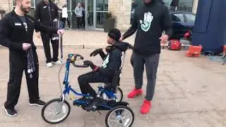 Adorable little boy finishes his first 5K race with handicap bike.