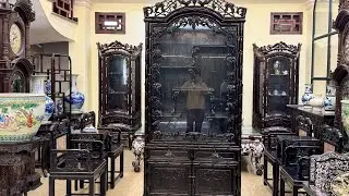 Unique wooden display cabinet made of rosewood, carved with bamboo and grapevine motifs.