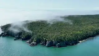 West Quoddy Head Lighthouse in the fog, Lubec, Maine USA and Campobello Island NB Canada.
