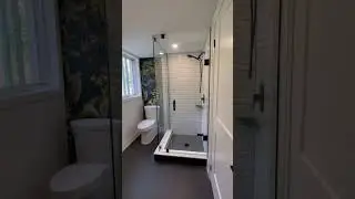 Corner custom glass shower with matte black hardware.