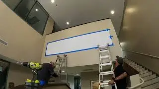 Installing three dimensional letters on an interior wall.
