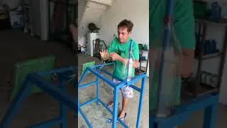 Man makes broom using recycled plastic bottles.