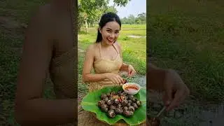 Stunning Girl in Straw Outfit Eats Snails in Lush Countryside