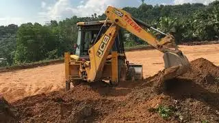jcb 3dx digging and gathering soil for making land surface  plane