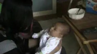 Kristianna bouncing on Mommy's knee