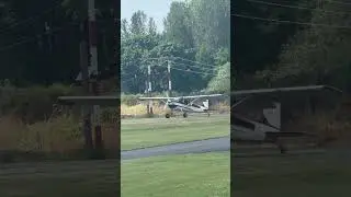 Cessna 180 taking off runway 15 at Harvey field