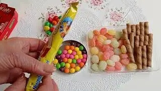 Sweet assortment unpacking of marmalade figures lollipops and dragees ASMR