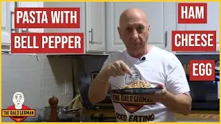 German makes Schinkennudeln - Pasta with Ham, Bell Pepper, Cheese, and Egg