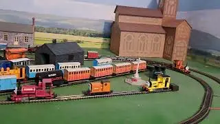 Bachmann Rheneas pulling 4 Brown 4 grey slate wagons and red brakvan