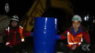 Greenpeace activists chain themselves to digger