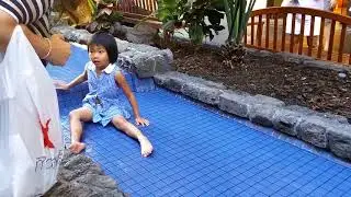 girl swims koi fish at ala moana shopping center