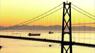 Vancouver - Aerial shot Lions Gate Bridge at sunset revealing tankers in background