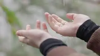 Rain falling on hands in slow motion - no Copyright