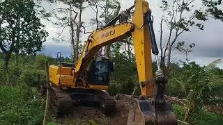 An excavator is making a road out of rocks Equipment & Operator Channel 