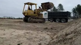 Loading topsoil with Caterpillar 955L track loader