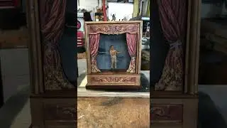 Changing the scenery, curtains, and character in Dan Strout's sand-powered automaton