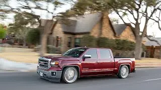 A statik dropped NNNBS GMC Sierra riding on true directional wheels cruises thru downtown Midland Tx