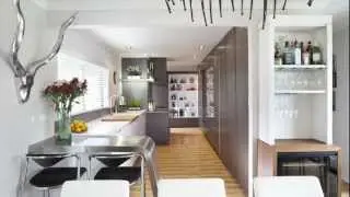 This kitchen features a multitude of special features and materials, and hides a complete laundry