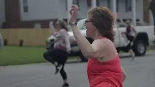 Zumba instructor teaching classes in neighborhood cul-de-sac