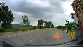 Overloaded Tractor front wheel in air in an uphill - watch till end