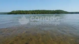 Clear lake water in Canadian cottage country stock video. Haliburton, Ontario, Canada. 4K.