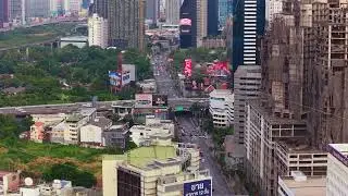 Aerial perspective showing cityscape of Bangkok, Thailand. Busy traffic moves along streets
