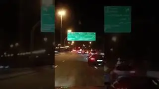Nighttime drive: cruising down a quiet street with a few brave souls on the Road