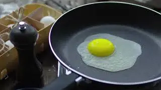 A person cooking sunny side up